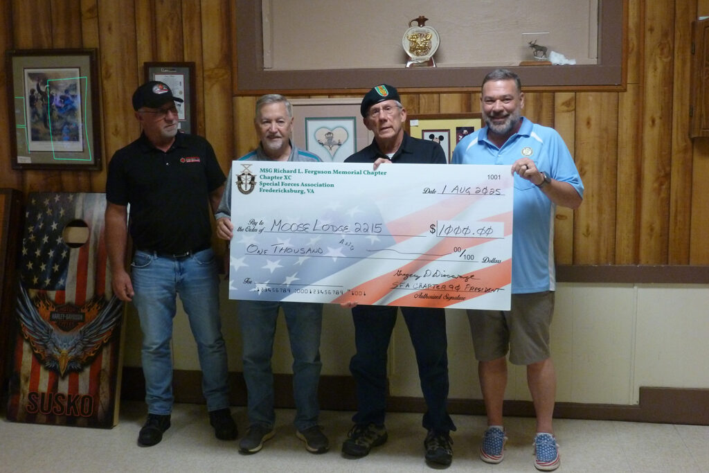 President Greg Discavage presents a check for $1000 to Moose Lodge 2215